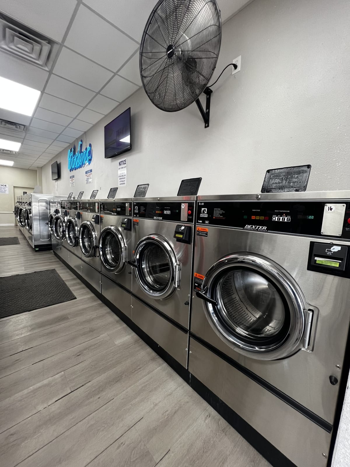 Row of modern Dexter front-load washers at Suds Laundromat