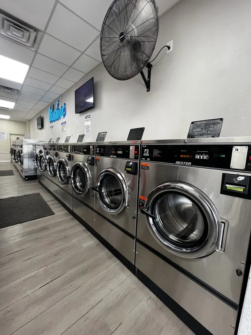Row of modern Dexter front-load washers at Suds Laundromat