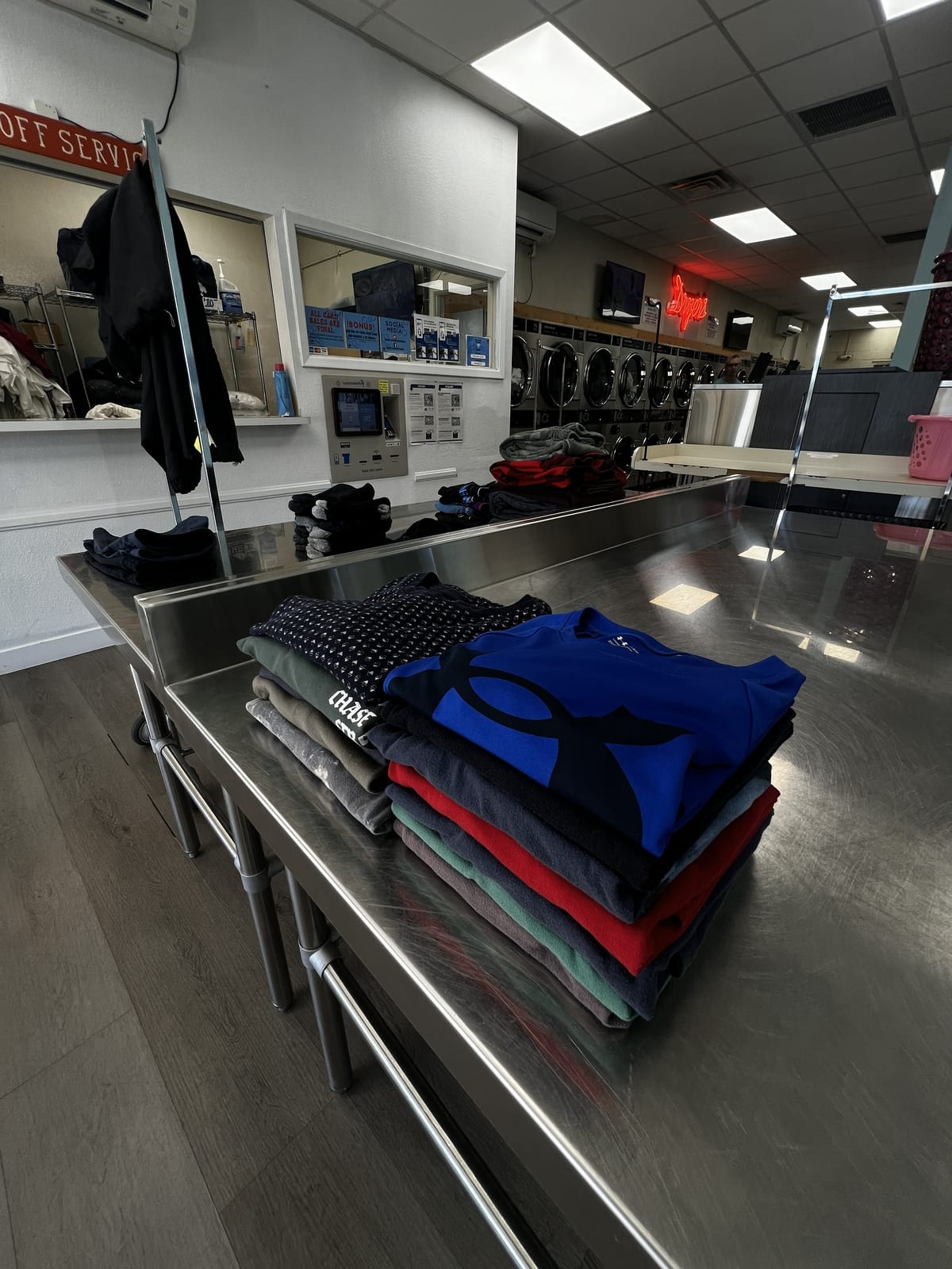 Neatly folded shirts and clothes from drop-off laundry service